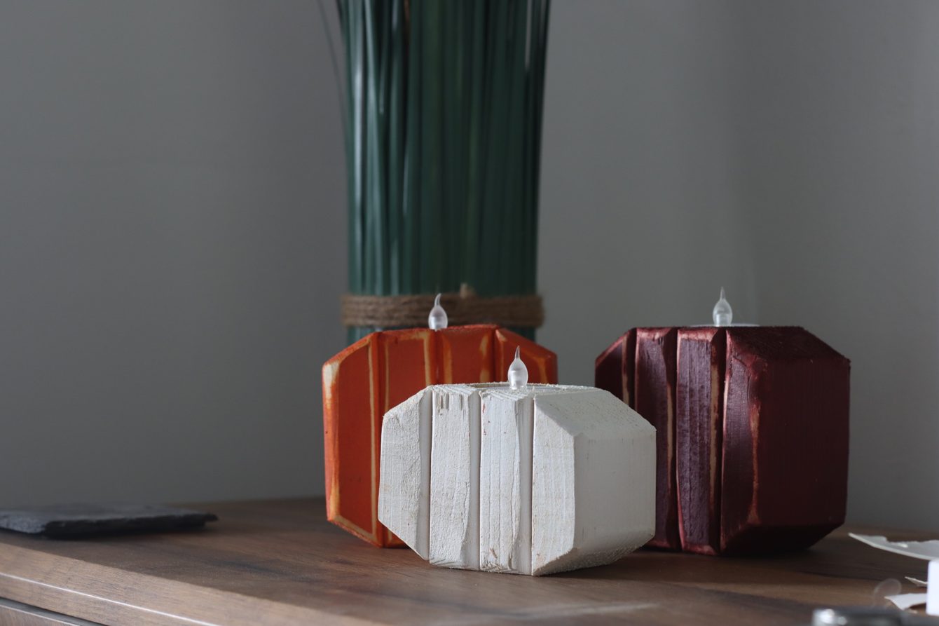 The same three tea light pumpkins by daylight, unlit, showing the hollow for the tea light.